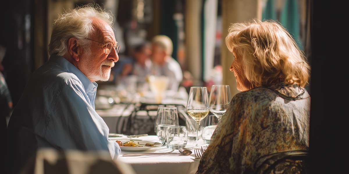 Older couple having dinner at a terraced restaurant